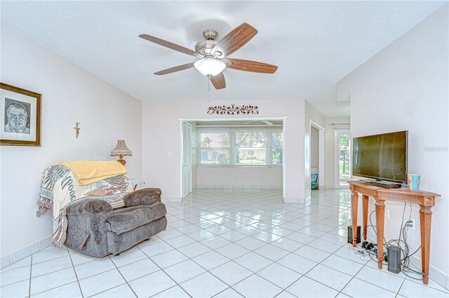 1655 S Highland Ave Unit B118, Clearwater, FL 33756 - living area with ceiling fan, light tile patterned floors, and a textured ceiling