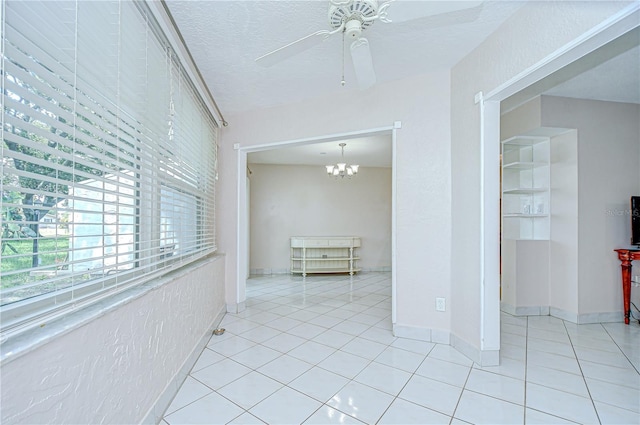 1655 S Highland Ave Unit B118, Clearwater, FL 33756 - spare room featuring a ceiling fan, tile patterned floors, a chandelier, and a textured ceiling