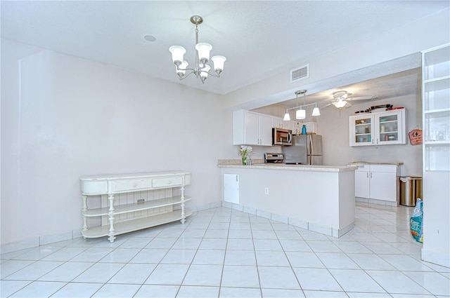 1655 S Highland Ave Unit B118, Clearwater, FL 33756 - kitchen featuring stainless steel appliances, white cabinets, a peninsula, and light countertops