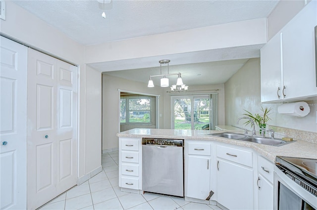1655 S Highland Ave Unit B118, Clearwater, FL 33756 - kitchen featuring dishwashing machine, light tile patterned flooring, light countertops, a peninsula, and a textured ceiling