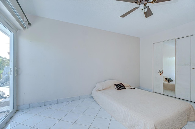 1655 S Highland Ave Unit B118, Clearwater, FL 33756 - bedroom featuring light tile patterned floors, ceiling fan, and a closet