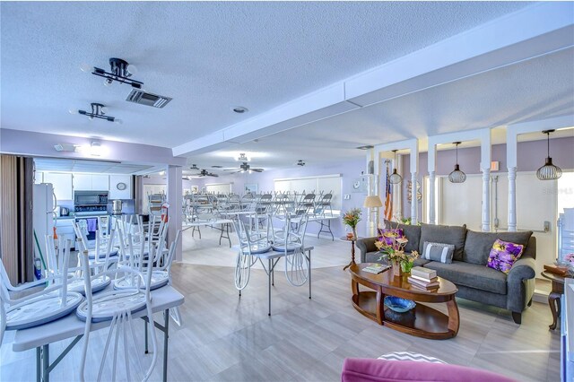 1655 S Highland Ave Unit B118, Clearwater, FL 33756 - living area with a textured ceiling and ceiling fan