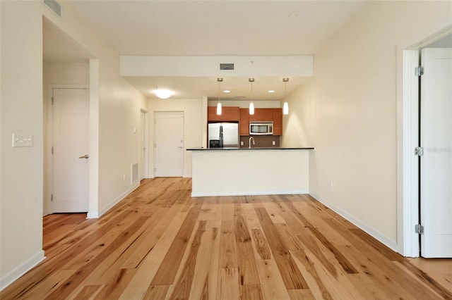400 4th Ave S Unit 301, Saint Petersburg, FL 33701 - unfurnished living room featuring light wood-type flooring, baseboards, and a sink