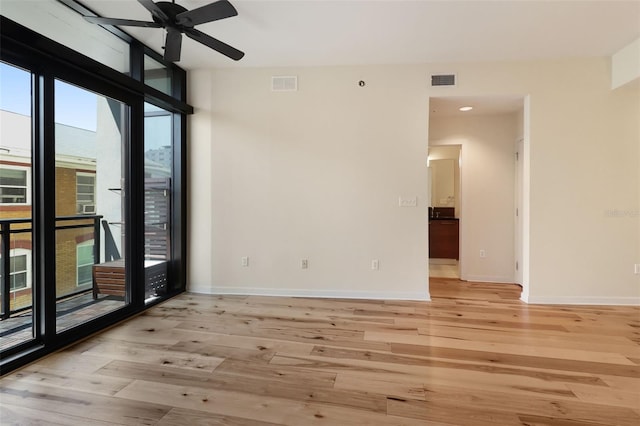 400 4th Ave S Unit 301, Saint Petersburg, FL 33701 - empty room with a ceiling fan, light wood-type flooring, baseboards, expansive windows, and recessed lighting