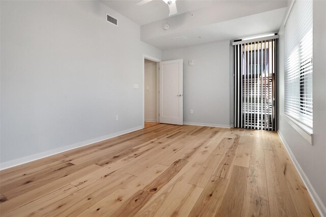 400 4th Ave S Unit 301, Saint Petersburg, FL 33701 - unfurnished room featuring light wood-type flooring, healthy amount of natural light, a ceiling fan, and baseboards