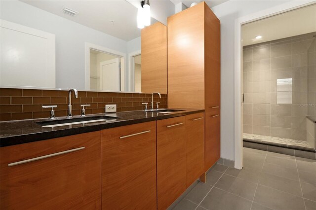 400 4th Ave S Unit 301, Saint Petersburg, FL 33701 - bathroom with double vanity, tile patterned floors, tasteful backsplash, and tiled shower