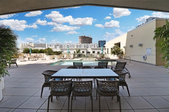 400 4th Ave S Unit 301, Saint Petersburg, FL 33701 - view of patio with a community pool and outdoor dining space