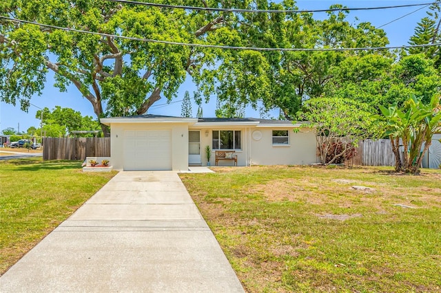 10599 111th Ave N, Largo, FL 33773 - view of front of house with stucco siding, an attached garage, and driveway