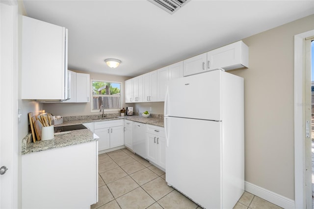 10599 111th Ave N, Largo, FL 33773 - kitchen with white appliances, a sink, light tile patterned floors, and white cabinetry
