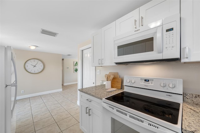10599 111th Ave N, Largo, FL 33773 - kitchen with white appliances, light tile patterned floors, white cabinetry, and baseboards