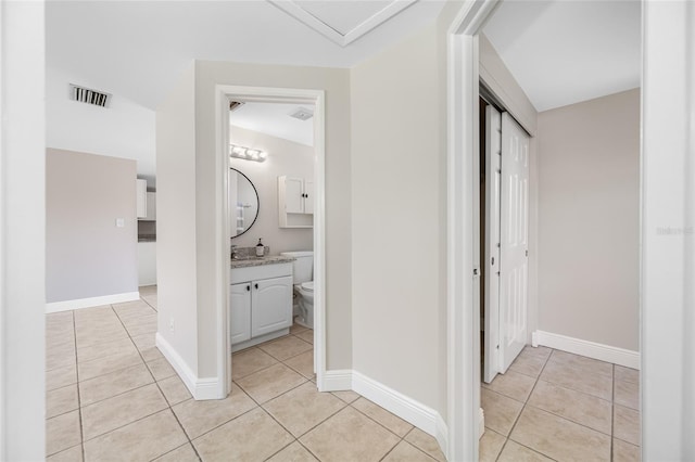 10599 111th Ave N, Largo, FL 33773 - corridor featuring light tile patterned floors and baseboards