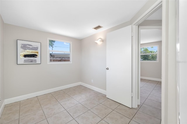 10599 111th Ave N, Largo, FL 33773 - empty room featuring light tile patterned floors and baseboards
