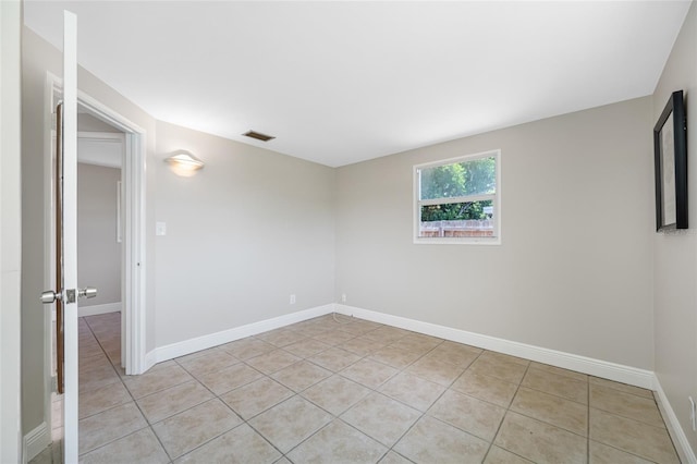 10599 111th Ave N, Largo, FL 33773 - empty room with light tile patterned floors and baseboards