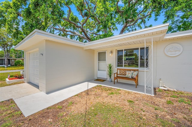 10599 111th Ave N, Largo, FL 33773 - property entrance with concrete driveway and an attached garage