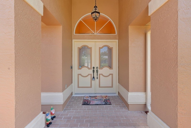 10228 Yellow Pine Way, Hudson, FL 34667 - property entrance featuring french doors and stucco siding