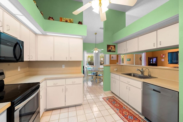 10228 Yellow Pine Way, Hudson, FL 34667 - kitchen featuring stainless steel appliances, a sink, a ceiling fan, light countertops, and high vaulted ceiling