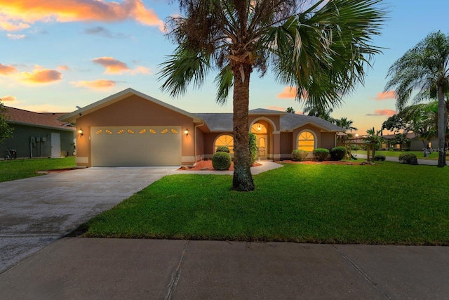 10228 Yellow Pine Way, Hudson, FL 34667 - single story home featuring a garage, concrete driveway, a yard, and stucco siding