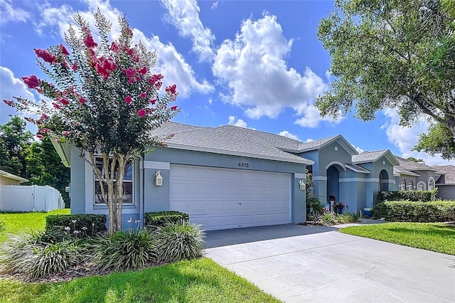 4315 Whittner Dr, Land O Lakes, FL 34639 - ranch-style home with stucco siding, an attached garage, and concrete driveway
