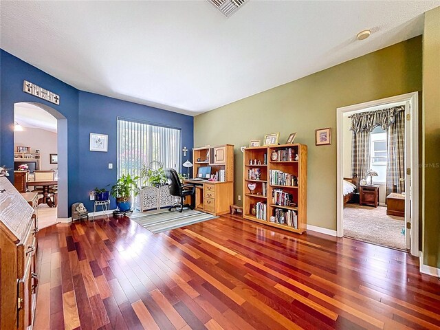 4315 Whittner Dr, Land O Lakes, FL 34639 - home office featuring arched walkways and hardwood / wood-style floors