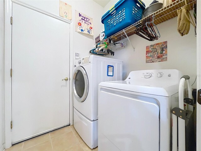 4315 Whittner Dr, Land O Lakes, FL 34639 - washroom with washer and dryer and light tile patterned floors