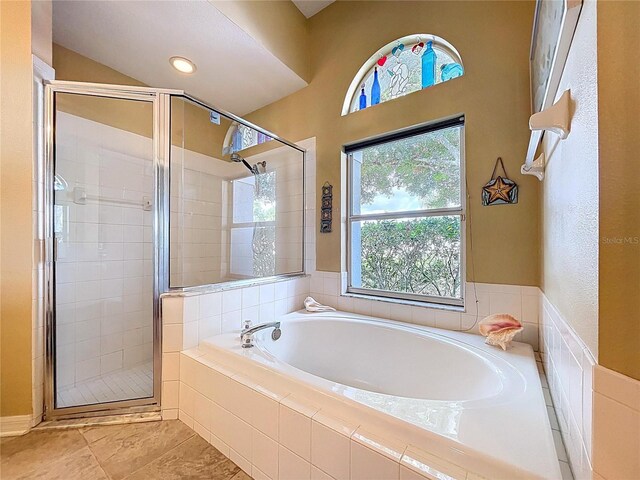 4315 Whittner Dr, Land O Lakes, FL 34639 - bathroom with a garden tub, a stall shower, and tile patterned flooring