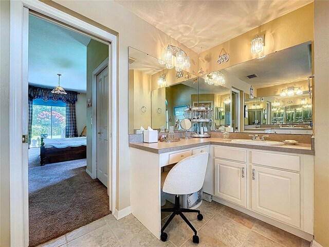 4315 Whittner Dr, Land O Lakes, FL 34639 - full bath with ensuite bathroom, vanity, tile patterned floors, and a chandelier