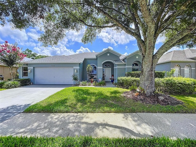 4315 Whittner Dr, Land O Lakes, FL 34639 - view of front of house with stucco siding, a garage, concrete driveway, and a front yard
