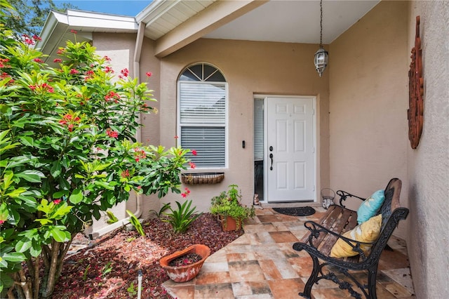 5143 Lochmead Ter, Zephyrhills, FL 33541 - doorway to property with stucco siding