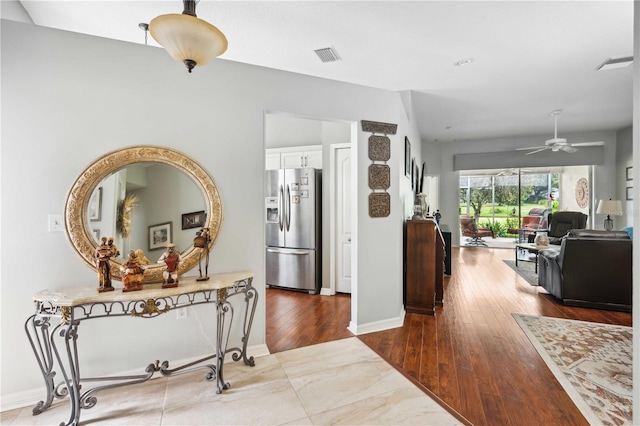 5143 Lochmead Ter, Zephyrhills, FL 33541 - hallway featuring wood finished floors and baseboards