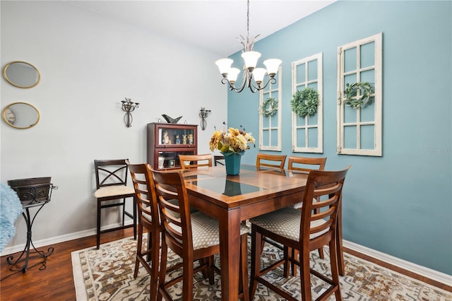 5143 Lochmead Ter, Zephyrhills, FL 33541 - dining area featuring a chandelier, wood finished floors, and baseboards