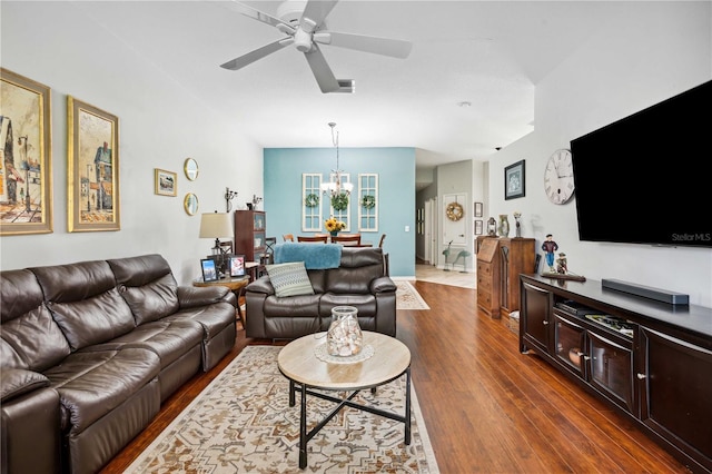5143 Lochmead Ter, Zephyrhills, FL 33541 - living area featuring dark wood-style floors, a ceiling fan, and a chandelier