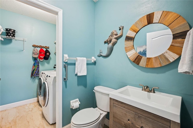 5143 Lochmead Ter, Zephyrhills, FL 33541 - half bathroom with washing machine and clothes dryer, vanity, baseboards, marble finish floors, and toilet
