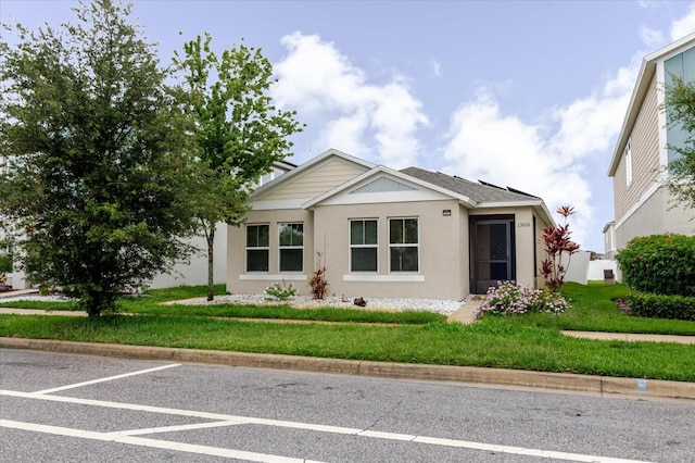 13016 Boggy Creek Dr, Riverview, FL 33579 - view of front of house with stucco siding and a front yard