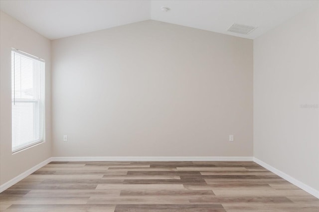 13016 Boggy Creek Dr, Riverview, FL 33579 - empty room featuring light wood-style floors, baseboards, and vaulted ceiling