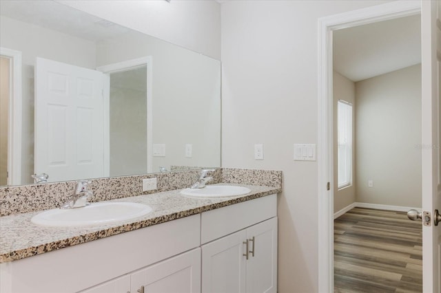 13016 Boggy Creek Dr, Riverview, FL 33579 - bathroom featuring double vanity, wood finished floors, and baseboards