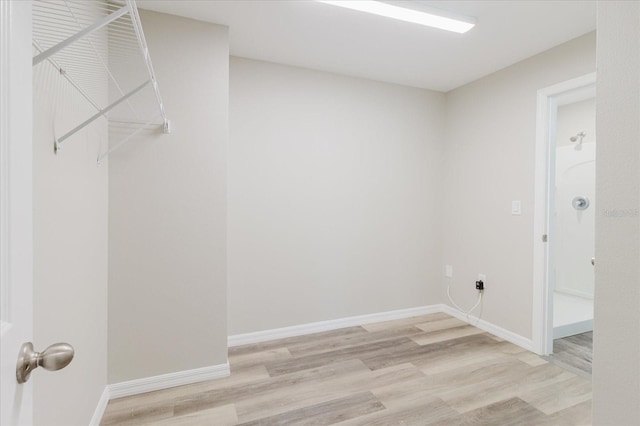 13016 Boggy Creek Dr, Riverview, FL 33579 - laundry room featuring light wood-style floors and baseboards