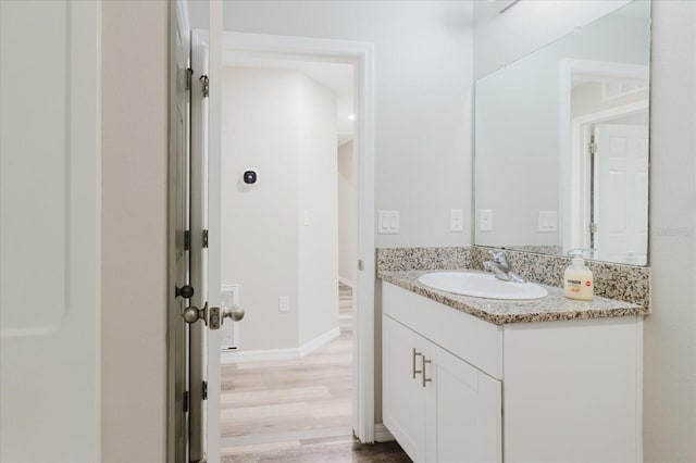 13016 Boggy Creek Dr, Riverview, FL 33579 - bathroom featuring vanity, wood finished floors, and baseboards