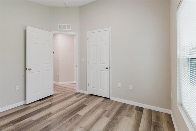 13016 Boggy Creek Dr, Riverview, FL 33579 - unfurnished bedroom with light wood-type flooring, baseboards, and a towering ceiling
