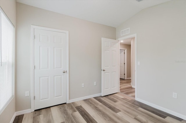 13016 Boggy Creek Dr, Riverview, FL 33579 - unfurnished bedroom with light wood-style floors, lofted ceiling, and baseboards