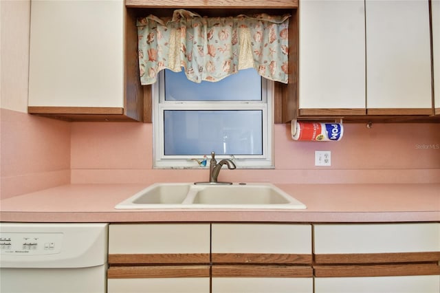 11000 Gulf Blvd Unit 703, Treasure Island, FL 33706 - kitchen featuring white dishwasher, a sink, light countertops, and white cabinetry