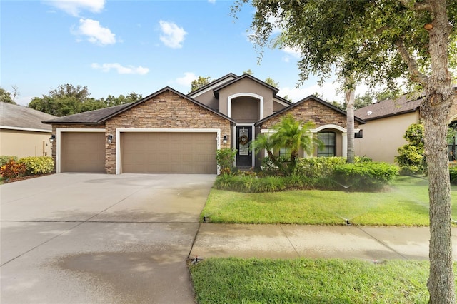 12729 Flatwood Creek Dr, Gibsonton, FL 33534 - single story home with stucco siding, an attached garage, driveway, a front yard, and stone siding