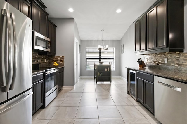 12729 Flatwood Creek Dr, Gibsonton, FL 33534 - kitchen with appliances with stainless steel finishes, beverage cooler, a chandelier, backsplash, and baseboards