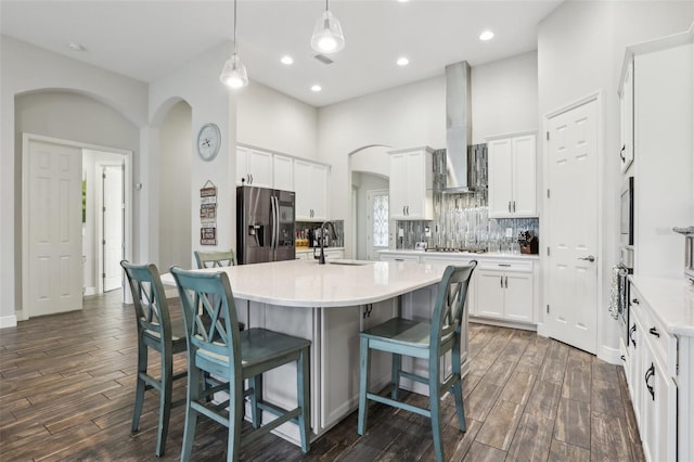 808 Vittorio Pl, Brandon, FL 33511 - kitchen with stainless steel appliances, arched walkways, island exhaust hood, dark wood-type flooring, and recessed lighting