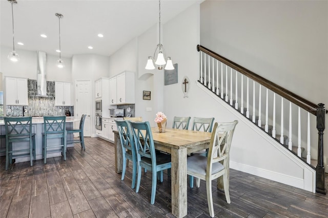 808 Vittorio Pl, Brandon, FL 33511 - dining area with a high ceiling, dark wood-type flooring, stairway, recessed lighting, and a chandelier