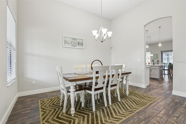 808 Vittorio Pl, Brandon, FL 33511 - dining room with dark wood finished floors, a chandelier, baseboards, and arched walkways