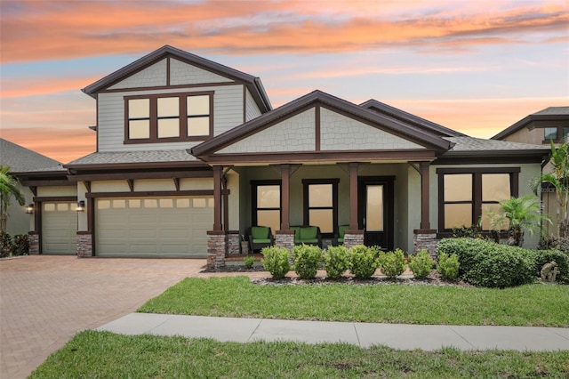 808 Vittorio Pl, Brandon, FL 33511 - craftsman house with covered porch, a front lawn, decorative driveway, a garage, and stone siding