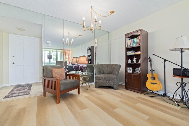 19029 US Highway 19 N Unit 3-1, Clearwater, FL 33764 - living area featuring a chandelier, light wood finished floors, and baseboards