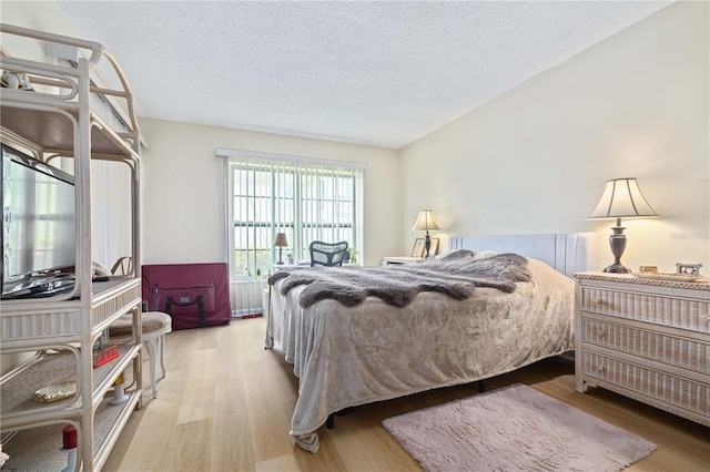 19029 US Highway 19 N Unit 3-1, Clearwater, FL 33764 - bedroom with wood finished floors and a textured ceiling