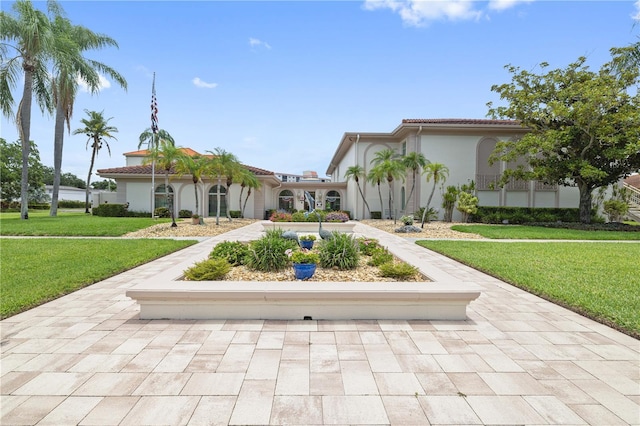 19029 US Highway 19 N Unit 3-1, Clearwater, FL 33764 - view of front of house featuring a front lawn, stucco siding, and a tile roof