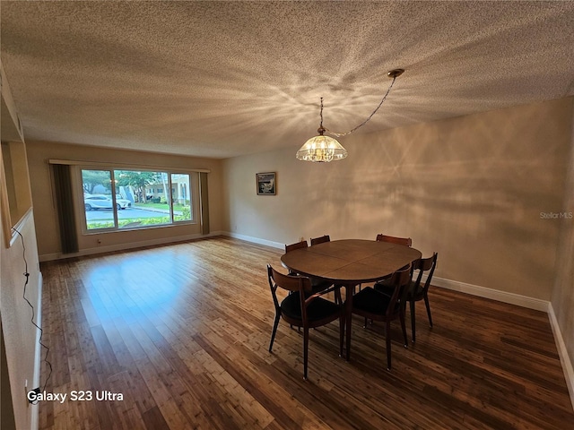 2221 Norwegian Dr Unit 15, Clearwater, FL 33763 - dining space featuring a chandelier, hardwood / wood-style flooring, baseboards, and a textured ceiling